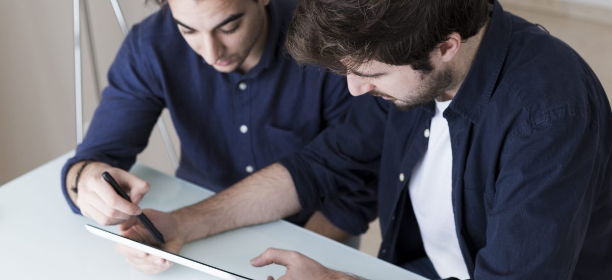 men-discussing-data-tablet men-discussing-data-tablet