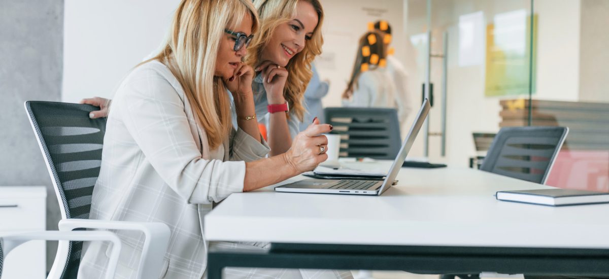Women is working on the project. Group of professional business people is in the office Women is working on the project. Group of professional business people is in the office.